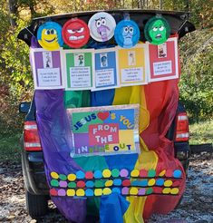 the back end of a vehicle decorated with colorful paper decorations and magnets on it