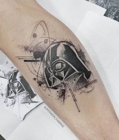 a star wars themed tattoo on the left arm and leg, with an image of darth vader's helmet