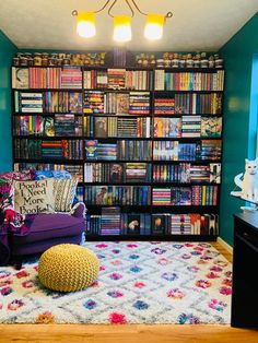 a living room with bookshelves full of books and a bean bag on the floor