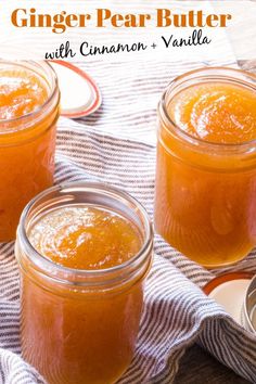 three jars filled with liquid sitting on top of a towel next to spoons and fork