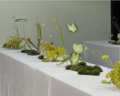 the table is covered with moss and flowers