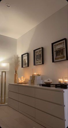 a room with candles and pictures on the wall