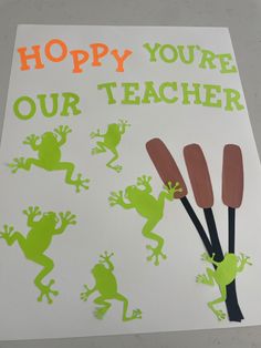 a paper cut out with frog images and the words hoppy you're our teacher on it