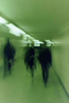 blurry photograph of people walking in a subway