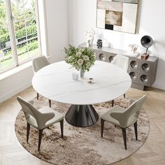 a white table with four chairs around it