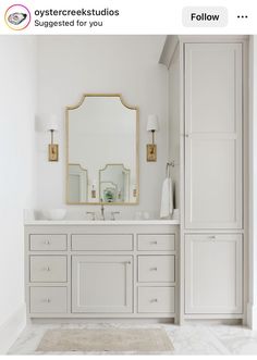 a white bathroom with two sinks and a large mirror above the sink is featured on instagram