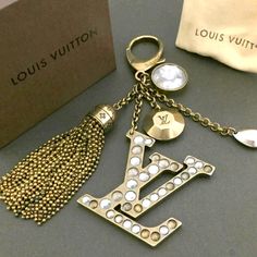 the louis vuitton keychain is next to a box and some other items