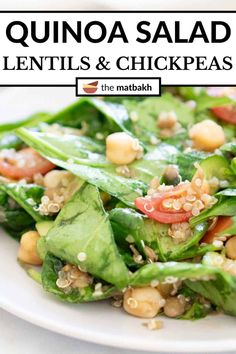 a white plate topped with spinach and chickpeas