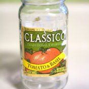 a jar filled with tomatoes sitting on top of a table