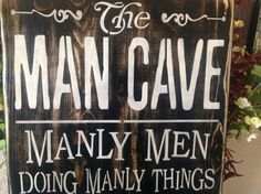 a wooden sign that says the man cave many men doing many things in his life