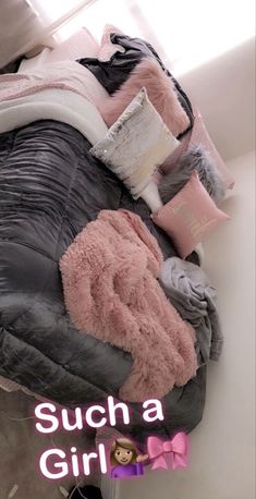 a pile of blankets and pillows on top of a bed with the words, such a girl