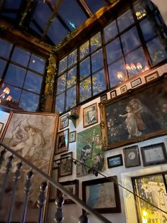 a staircase with many framed pictures on the wall