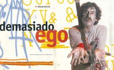 a man holding a guitar in front of graffiti covered wall with the words demasiado ego written on it