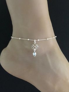 Genuine Lotus Blue Topaz AnkletMinimalist and Dainty Rolo Beaded Lotus Blue Topaz Charm AnkletANKLET FEATURES:Metal:  All components are made from solid .925 Sterling Silver Model is wearing 10" in length  solid .925 Sterling Silver Rolo Bead ChainChain Length:  9 inch + 1 inch extension Measurement:  Natural Lotus Blue Topaz PendantHeight: 20MM Width:  14MMYour Dainty Rolo Beaded Lotus Blue Topaz Anklet will arrive in a gift box, beautifully wrapped and ready for giftingPlease send me a message Silver Adjustable Spiritual Anklets, Adjustable Sterling Silver Anklets For Wedding, Silver Dainty Anklets For Wedding, Adjustable Sterling Silver Wedding Anklets, Wedding December, Beaded Ankle Bracelets, Silver Model, Beaded Ankle, Heart Anklet