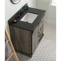 a bathroom with a sink, mirror and tiled flooring in the corner is shown