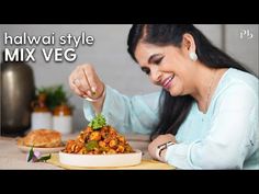 a woman sitting at a table with food in front of her and the words halwali style mix veg