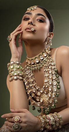 a woman with jewelry on her face and hands