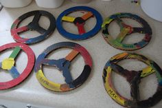 four wooden circles with different colors and numbers on them sitting on a white counter top