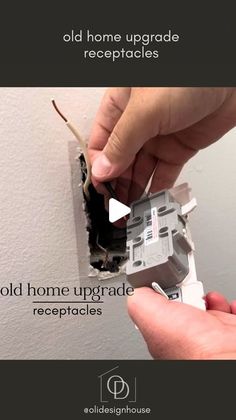 an old home upgrade receptacle is being repaired with the help of someone's hands