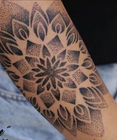 a person with a black and white tattoo on their arm