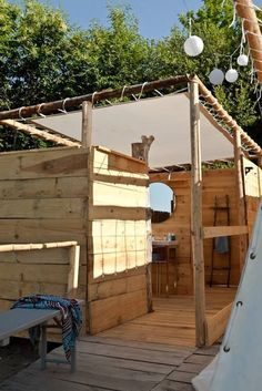 an image of a tent made out of pallets and wooden planks with a teepee