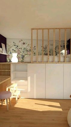 a living room with wooden floors and white furniture in front of a wall mounted bookcase