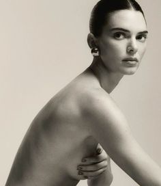 black and white photograph of a naked woman with her hand on the back of her shoulder