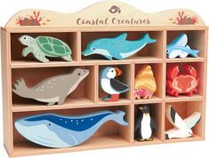 a wooden toy shelf filled with different types of sea animals