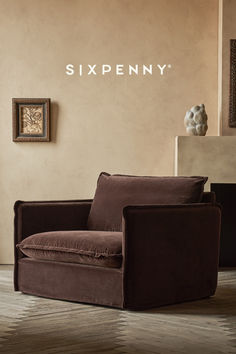 a brown chair sitting in front of a wall with the name sixpenny on it