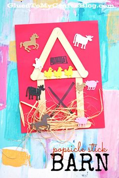 an art project made out of popsicle sticks and paper with farm animals on it