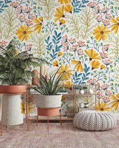 two potted plants are sitting next to each other in front of a colorful wallpaper