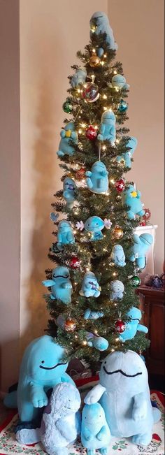 a christmas tree decorated with blue stuffed animals