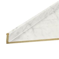 the corner of a white marble shelf with gold trimmings and a golden edge