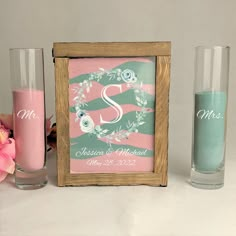 two vases, one with pink flowers and the other with green