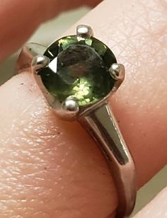 This is a gorgeous antique designer signed Natural Green Sapphire Solitaire Ring. I love all colors of sapphires but Green is quite special and very rare. The round brilliant stone is approximately 1.39 ctw. It is set in a classic platinum setting. 4 grams. It is currently a size 5.25 but very easily sizable by any local jeweler. Personally, I think it would make an amazing engagement ring. It is unusual, special and a rare classic. Thank you kindly. Green Gemstone Platinum Ring, Heirloom Green Round-cut Diamond Ring, Green Solitaire Sapphire Ring In Sterling Silver, Green Solitaire Crystal Ring In Sterling Silver, Vintage Eternity Band, Green Sapphire Ring Sterling Silver, May Birthstone, Baguette Diamond Band, Yellow Gold Solitaire Ring, Solitaire Ring Set