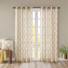 a living room with white curtains and wooden floors