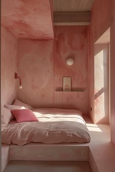 a bedroom with pink walls and a bed in the corner, next to a window