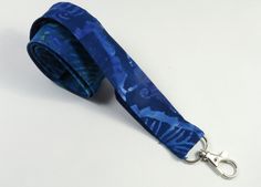 This cute lanyard has beautiful batik tie dye in blue. This lanyard is very beautiful in person. You can have a wardrobe of lanyard to match your outfit. This lanyard is made of soft 100% cotton fabric to give a comfortable feel around your neck. This lanyard is easy to take care. You can spot clean and throw in a washer and hang dry. If you want you can iron and it is ready to use. These lanyards are perfect if you have metal allergy. Each of these lanyards will have a slight different pattern Handmade Blue Lanyards As Gifts, Handmade Blue Lanyard As Gift, Handmade Blue Lanyards For Gifts, University Lanyard Design, University Lanyard, Lanyard Blue, Cute Lanyards, Fabric Lanyard, Blue Camouflage