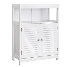 a white cabinet with shutters on the doors and shelves above it is isolated against a white background