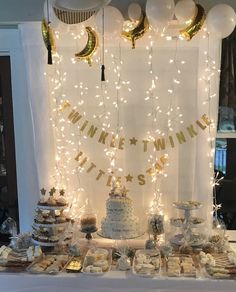 a table topped with lots of desserts and balloons