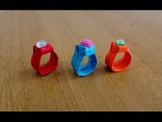 three pieces of origami sitting on top of a wooden table next to each other