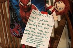 a spiderman doll next to a sign that says hey hey, it's back to school today