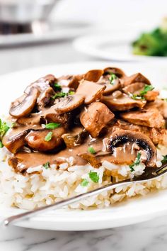 a white plate topped with rice and mushrooms