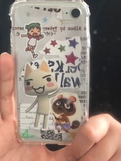 someone holding up their phone case with stickers on it