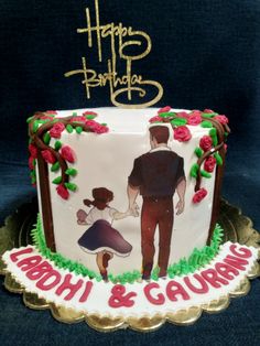 a decorated birthday cake with an image of a man and woman holding hands on top