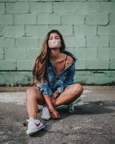 a woman sitting on the ground with her face painted