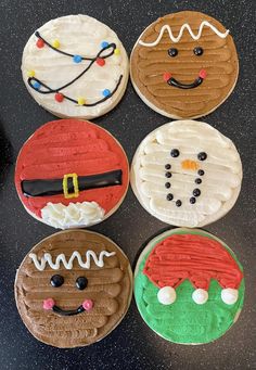 six decorated cookies sitting on top of a counter