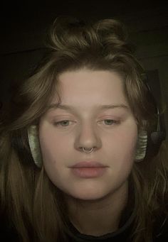 a young woman with headphones on her ears