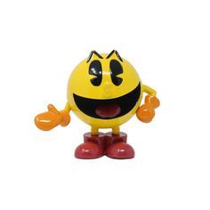 a yellow toy with black eyes and red feet is standing on one foot while smiling