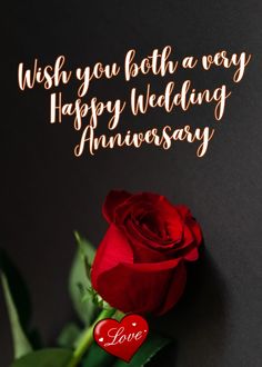 a red rose sitting on top of a table next to a black background with the words, wish you both a very happy wedding anniversary